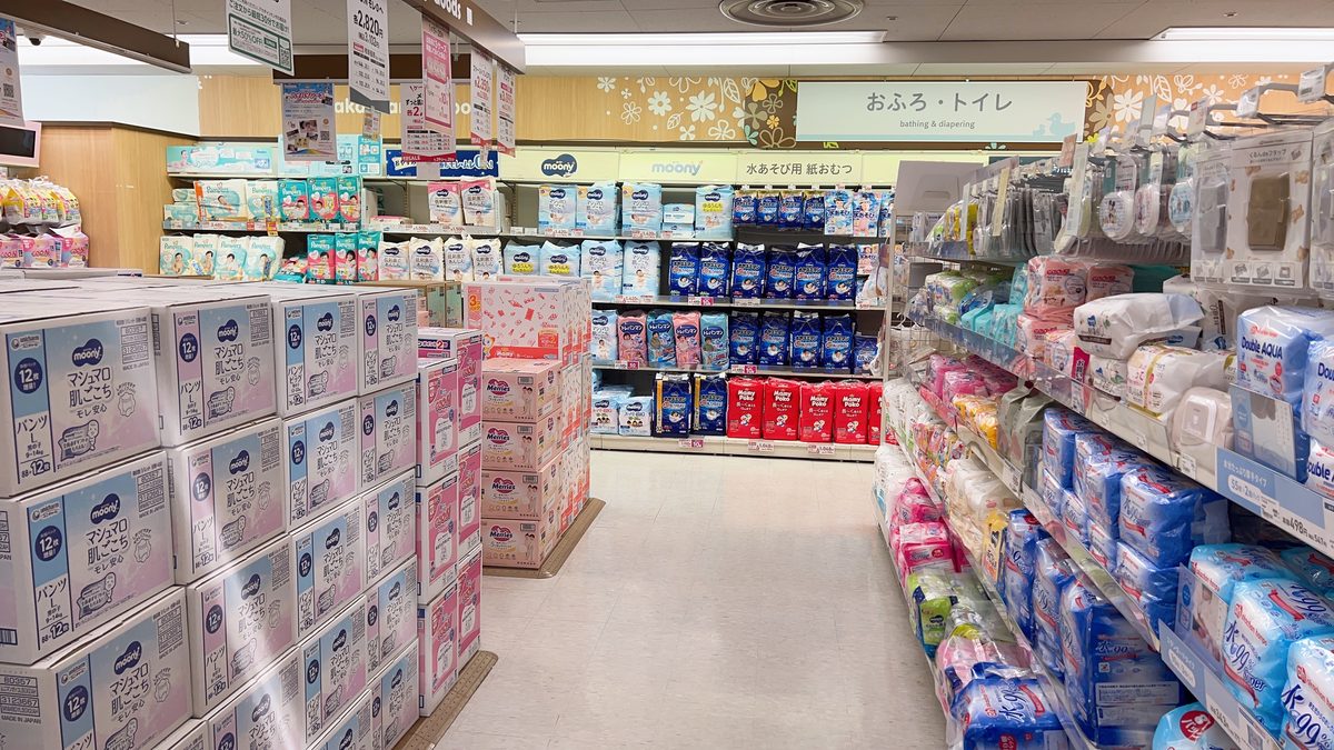 Akachan Honpo diaper aisle with large packs stacked high in a dedicated section labeled bath and toilet